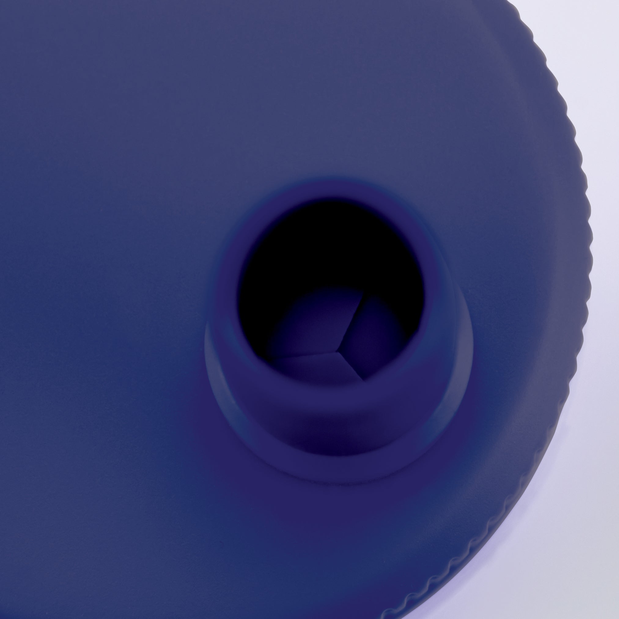 Close-up of the Pancake Pen 2.0's circular opening—resembling pancake shapes—with part of its textured edge set against a white background.