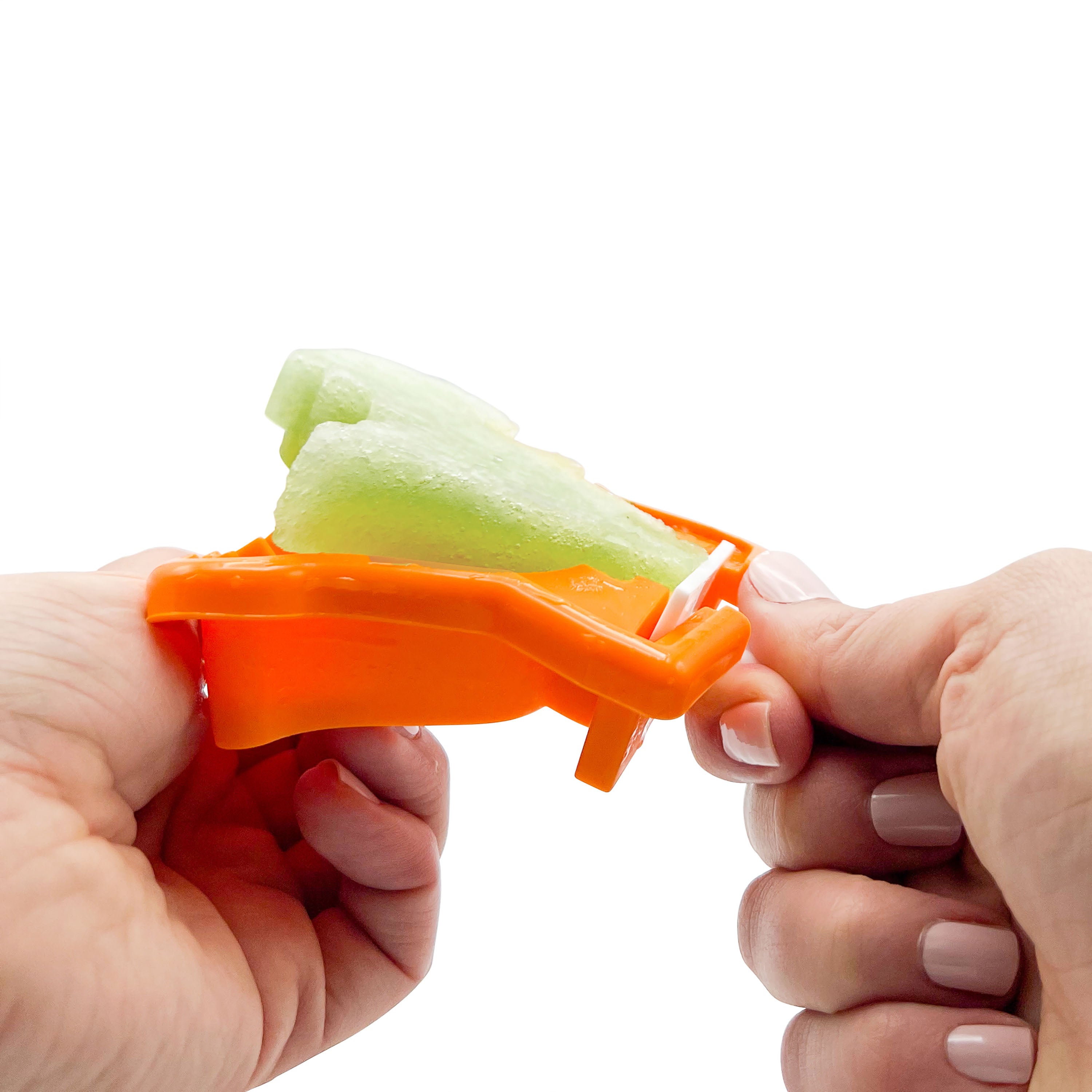 Close-up of hands removing a green popsicle from the Pop Molds Stackable silicone mold against a white background.