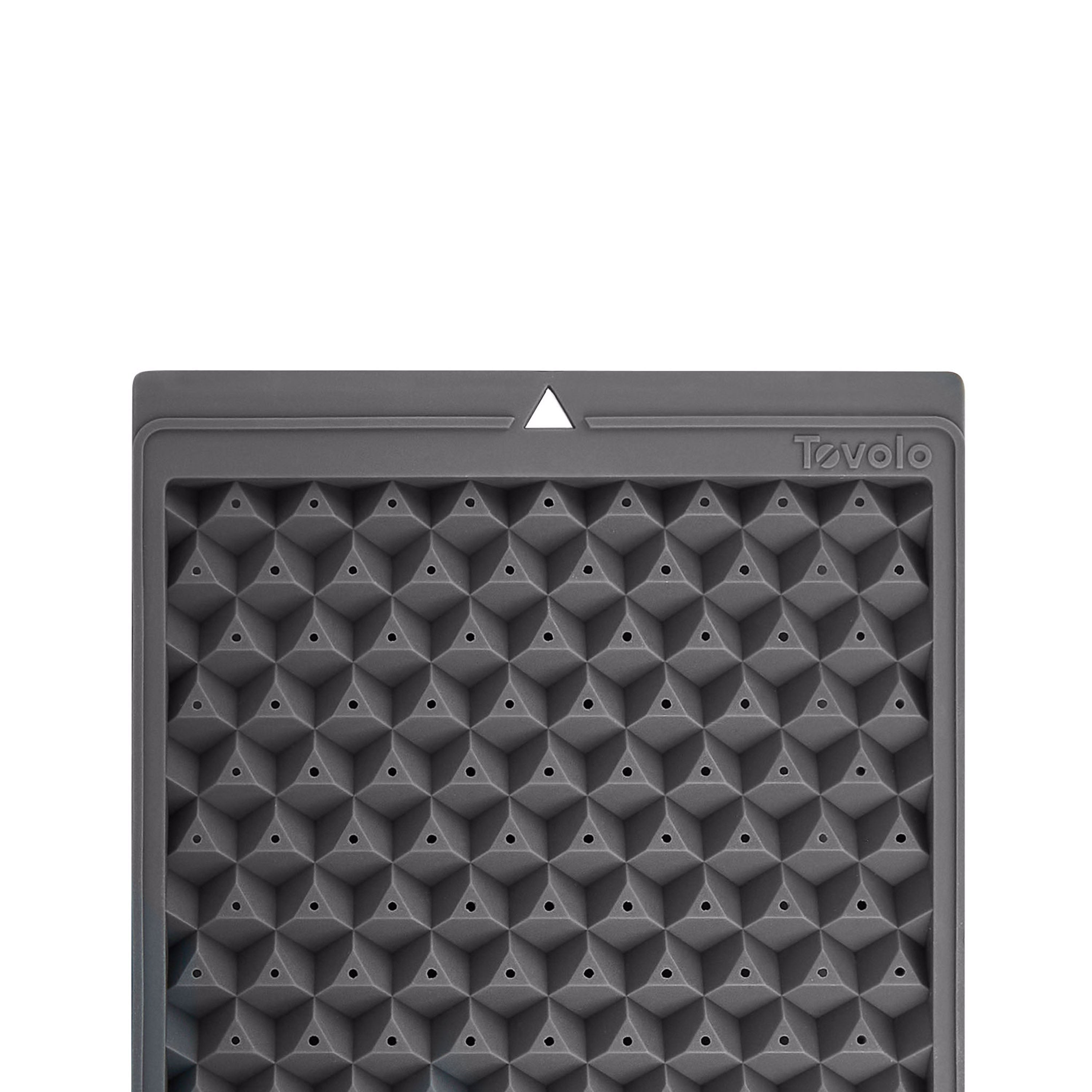 The Twist and Release Mini Ice is a gray silicone ice tray with a diamond pattern and small pyramid-shaped molds, featuring a single white triangle at the top center and Tovolo branding embossed in the upper right corner.
