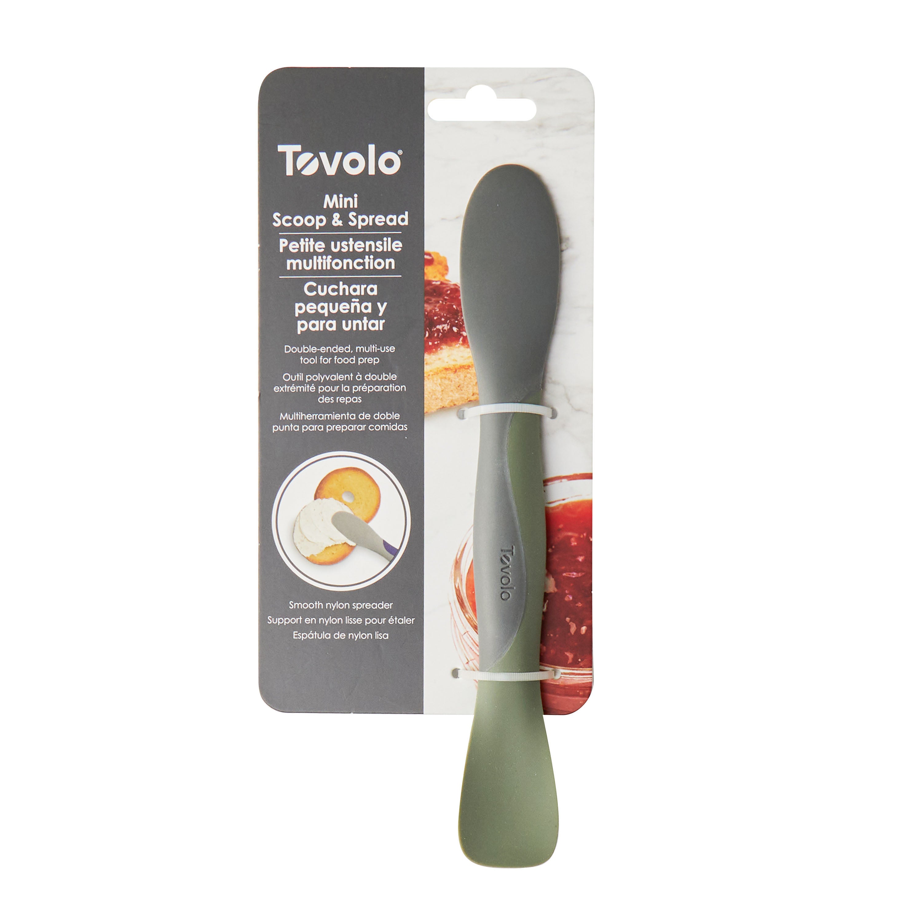 A Scoop and Spread kitchen tool in packaging, showcasing a two-sided gray and green spatula and English, French, and Spanish text highlighting its multifunction scoop and spread use—a baker's best friend.