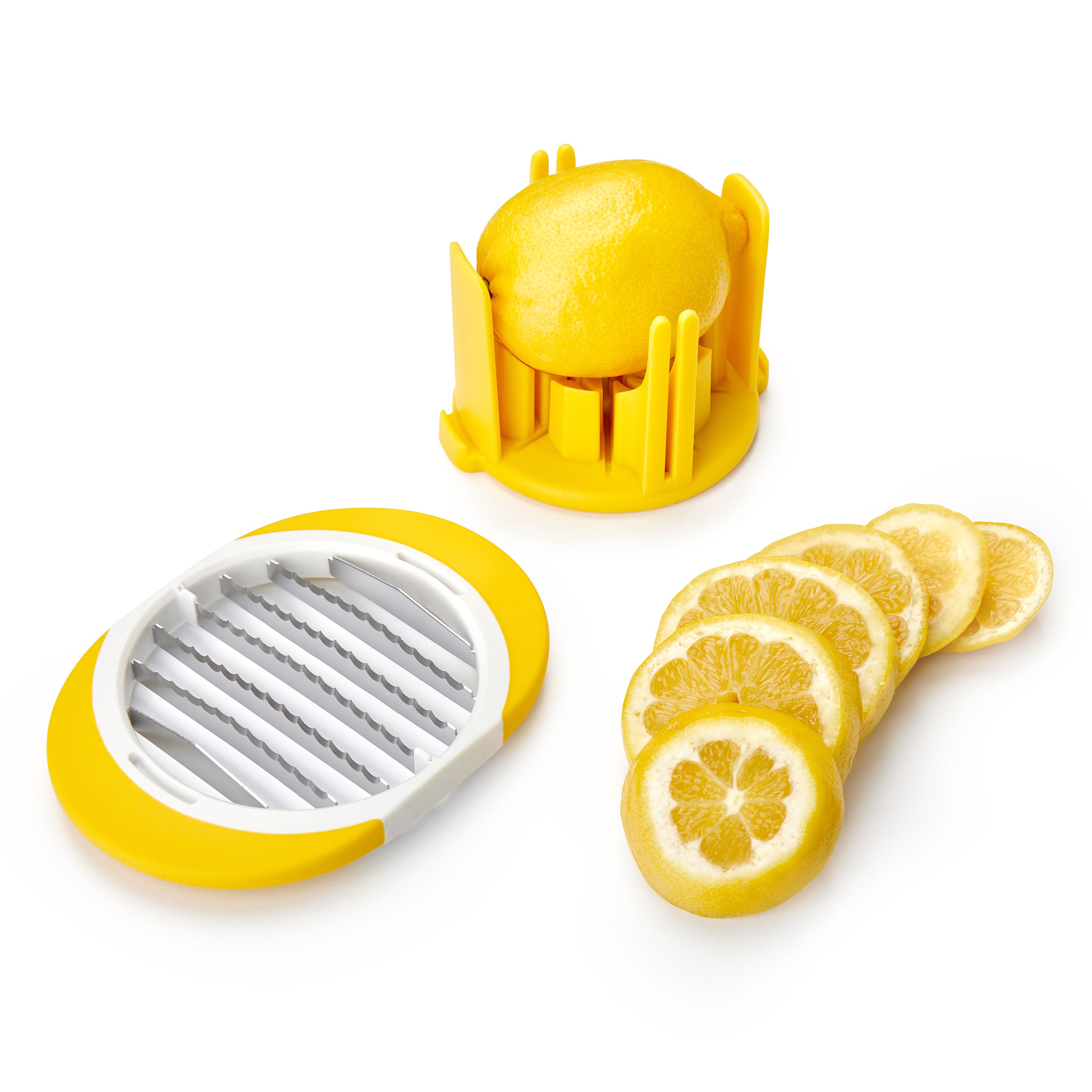 A yellow and white Citrus Slicer and Wedger holds a lemon, its stainless steel blades removed, with several evenly sliced lemon pieces arranged nearby.