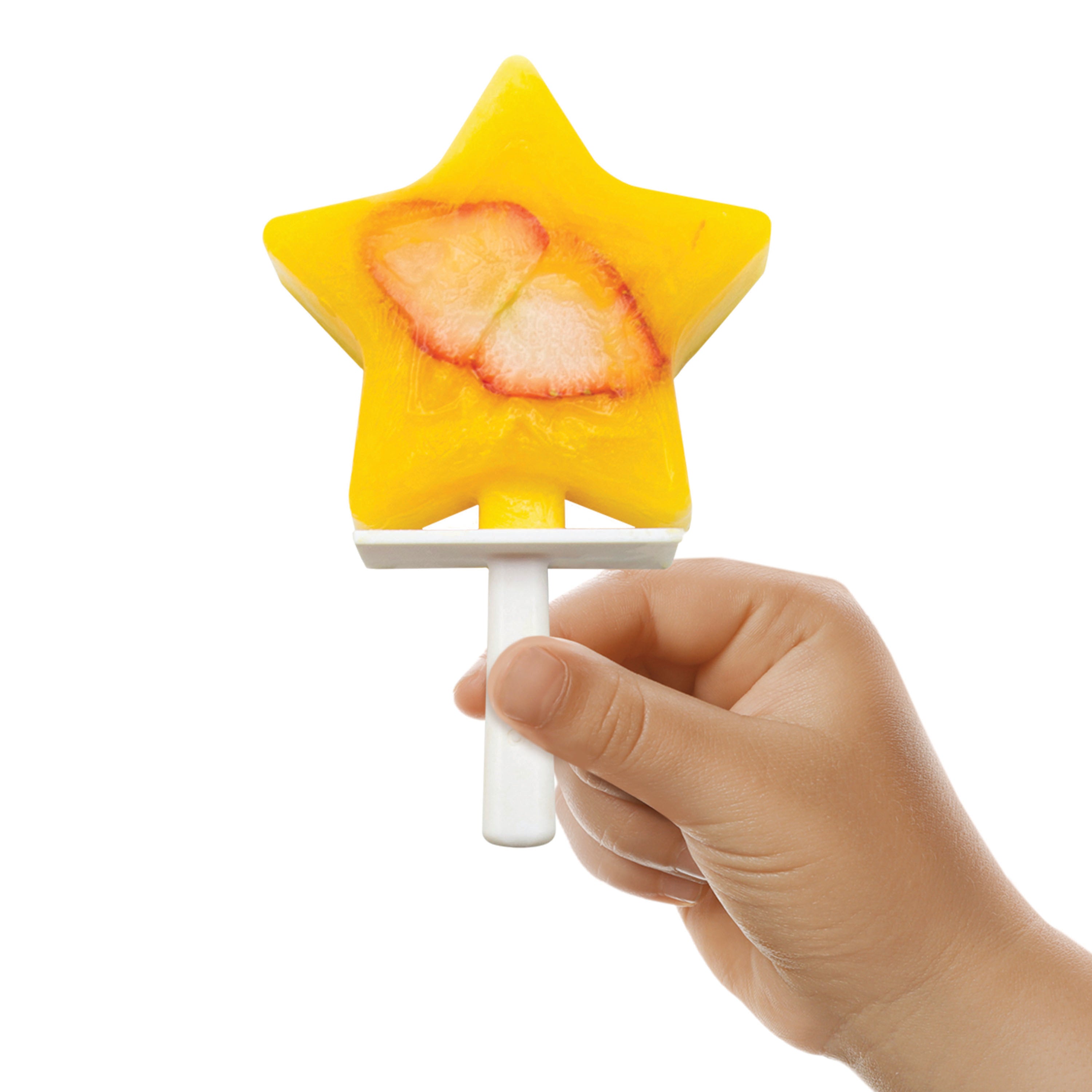 A child holds a yellow star-shaped popsicle with strawberry slices, made using Pop Molds Stackable, against a plain white background.