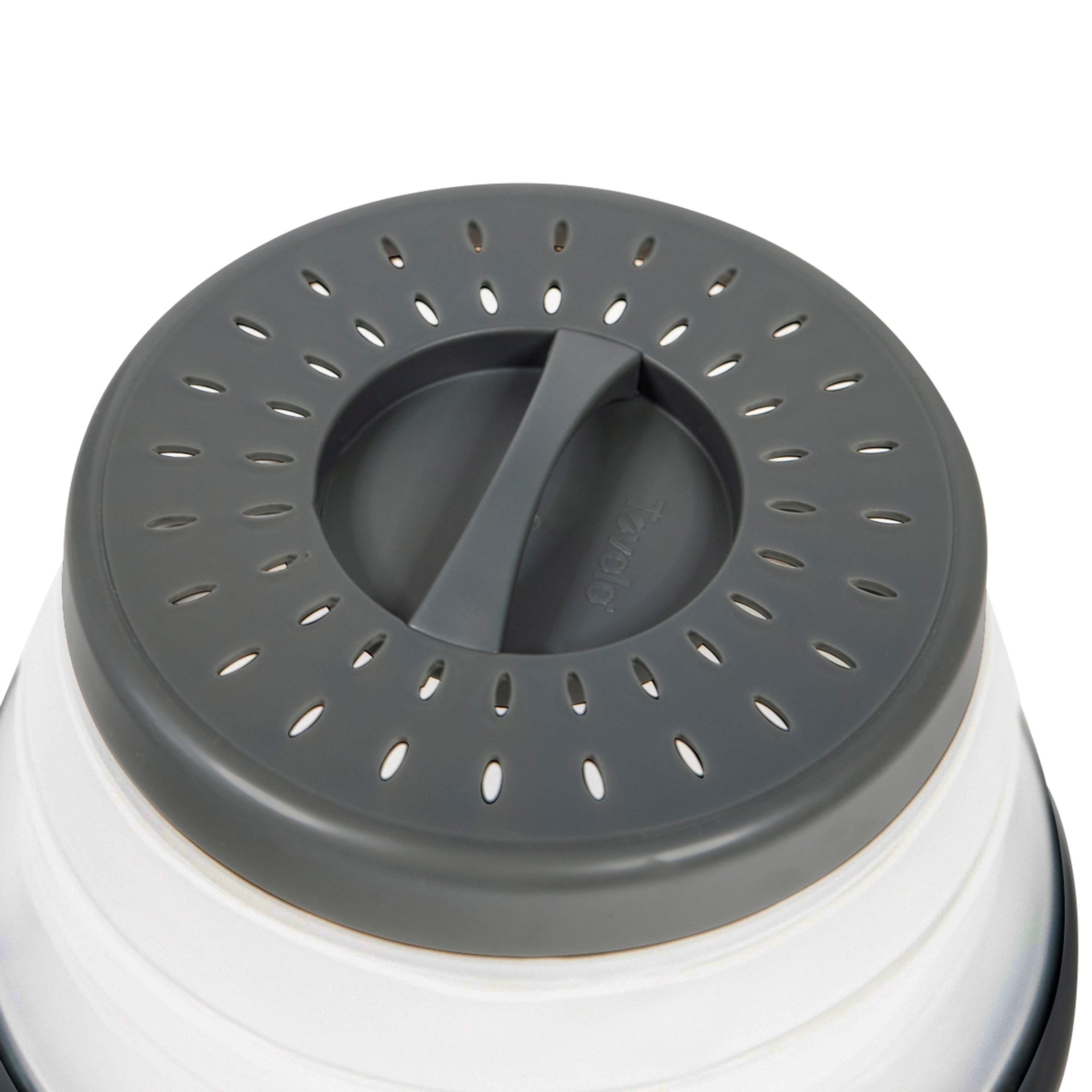 Close-up of the gray Collapsible Microwave Food Cover featuring high heat-resistant plastic, multiple small oval holes in circular patterns, and a central raised tab for easy lifting, designed for microwave venting, straining, or pouring.