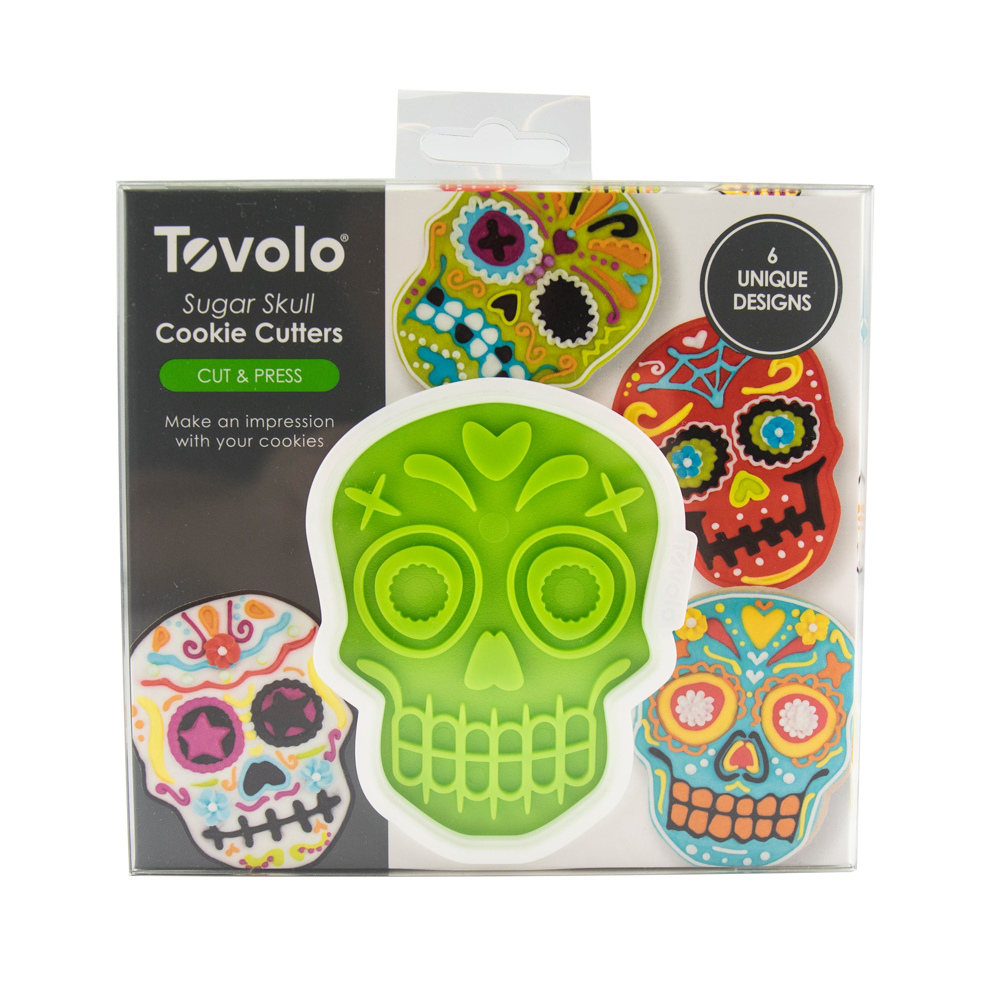 Box of Skull Cookie Cutters featuring a green skull-shaped cutter in the center and decorated sugar skull cookies—perfect for festive Christmas treats; includes 6 unique designs.