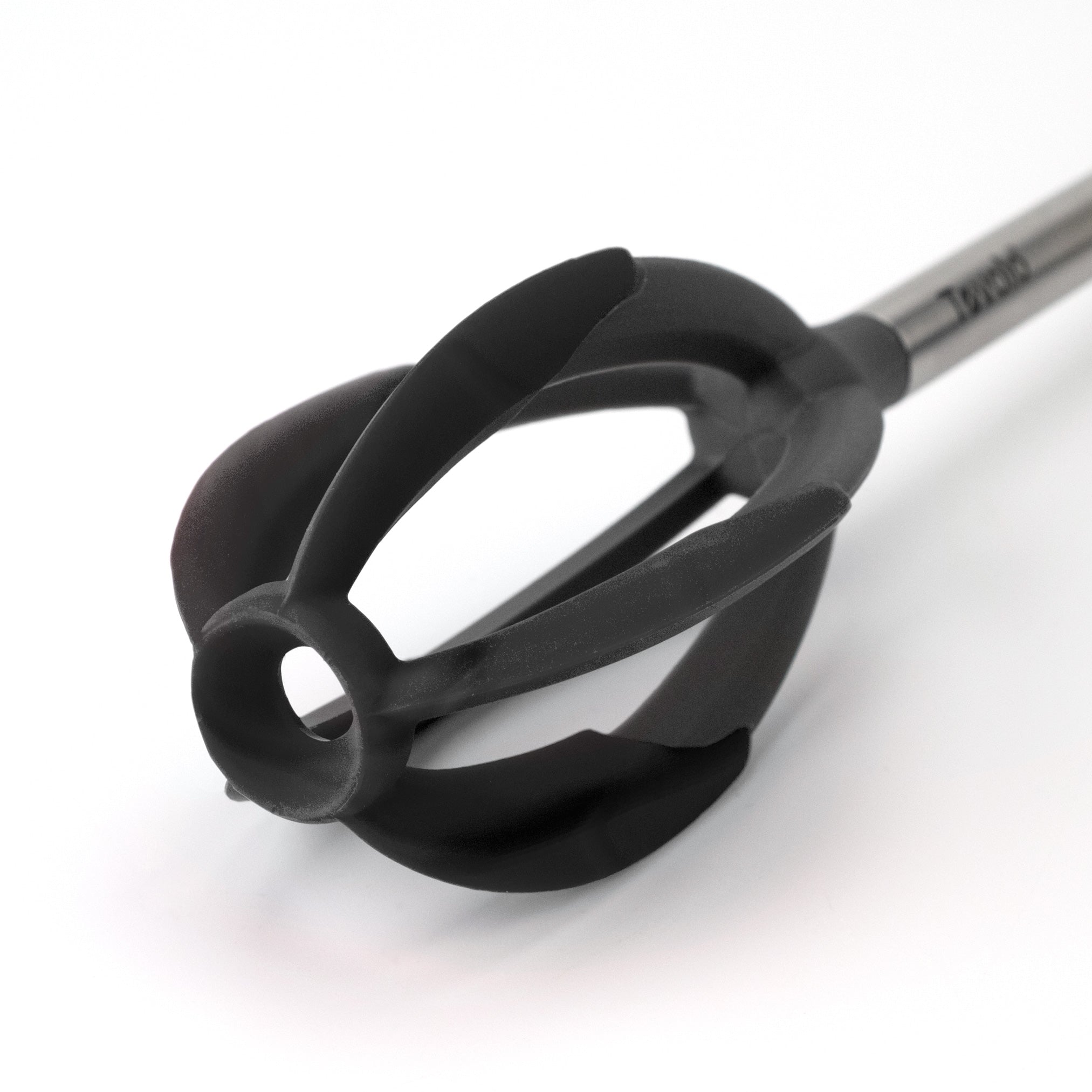A close-up of the Better Batter Tool, a black, flower-shaped silicone kitchen whisk with a stainless steel handle, set against a white background.
