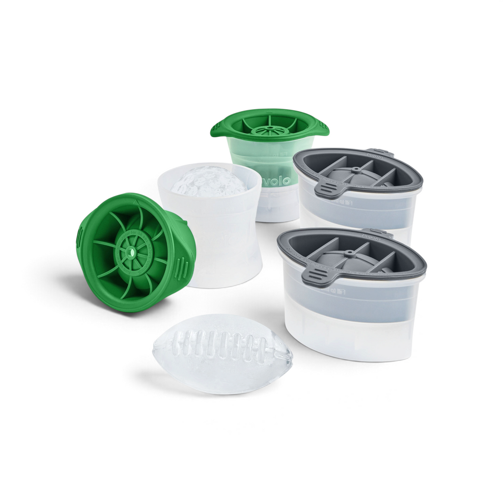 The tovolo Golf and Football Ice Molds (Set of 4) create football-shaped ice; shown with lids on/off and a finished clear piece. These stackable molds are ideal for game day drinks.