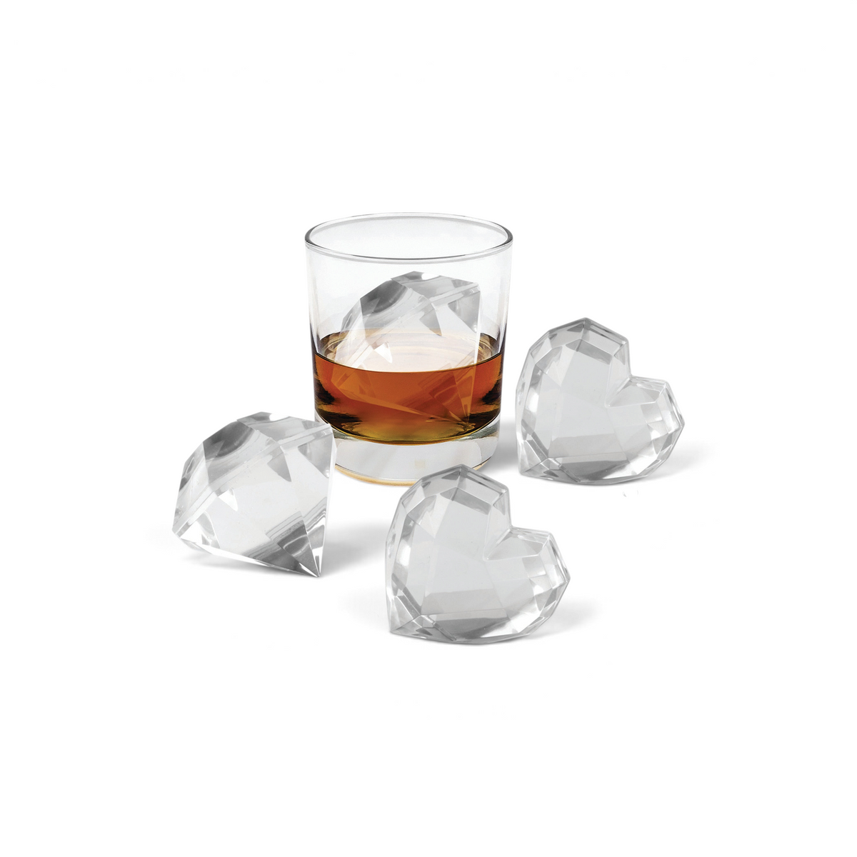 A glass of whiskey with a large, faceted heart-shaped ice cube made using tovolo’s Heart and Diamond Ice Molds (Set of 4), accompanied by three similar cubes on a white surface.