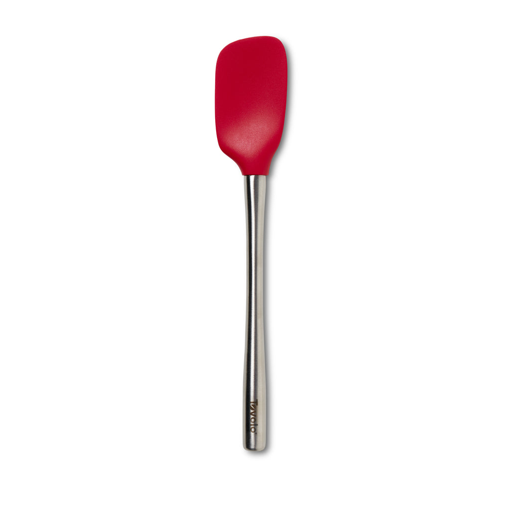 The tovolo Flex-Core Silicone and Stainless Steel Spoonula, shown upright on a white background, features a sturdy stainless handle and red silicone head—your versatile tool for baking and mixing tasks.