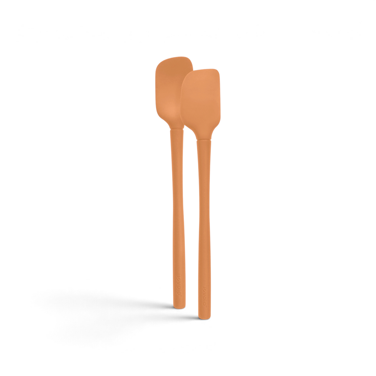 The tovolo Flex-Core Silicone Mini Spatula + Spoonula set includes two orange, heat-resistant utensils with long handles, displayed side by side on a white background.