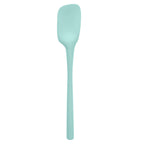The Flex-Core Spoonula features an ergonomic long handle and a flat, slightly curved light blue blade, making it ideal for comfortable cooking and baking.