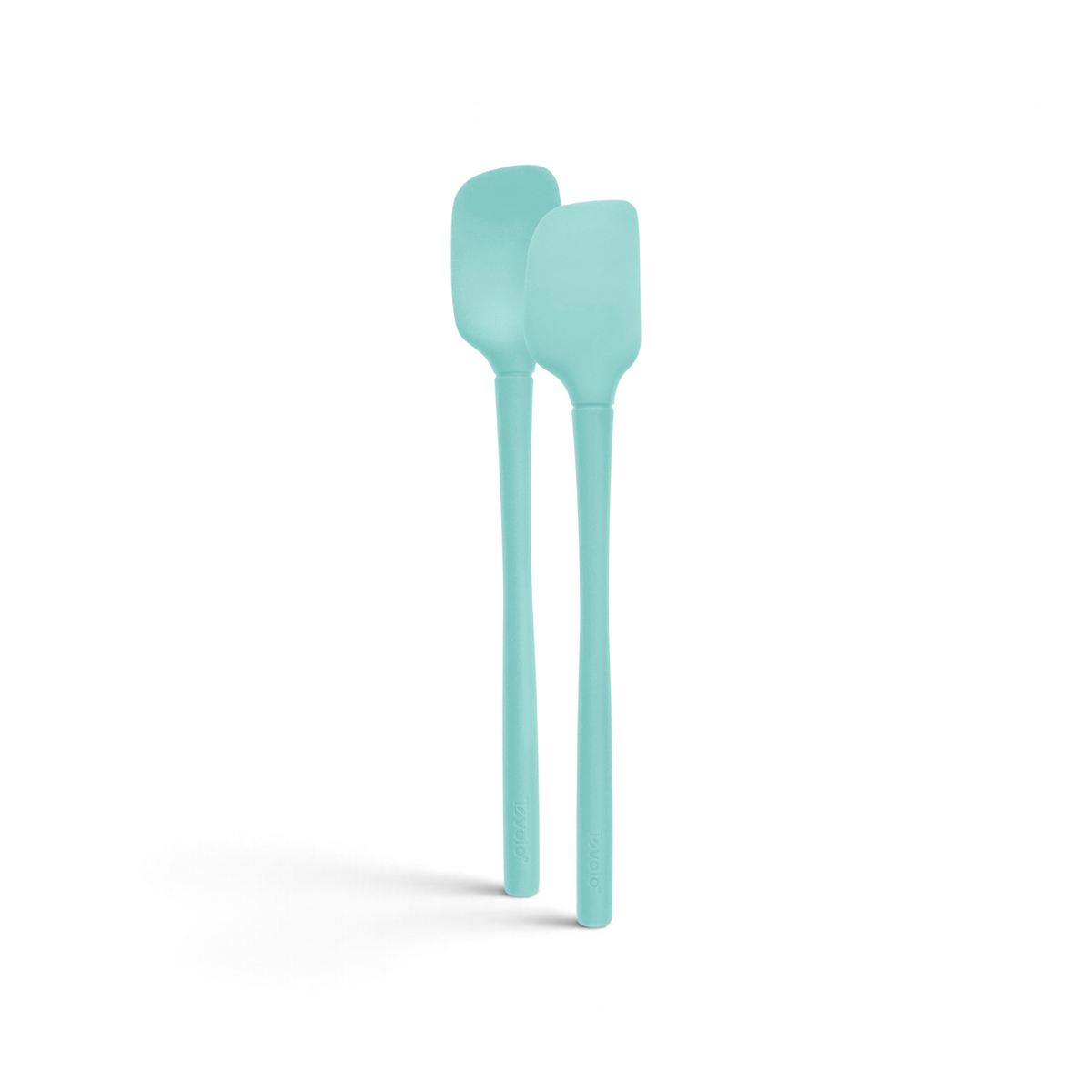 The tovolo Flex-Core Silicone Mini Spatula + Spoonula, in light blue with long handles, stand upright side by side against a white background, highlighting these heat-resistant kitchen utensils.