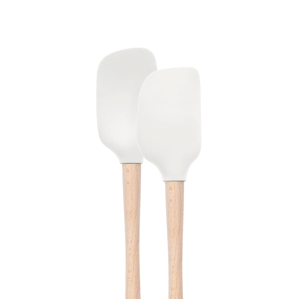 Two white tovolo Flex-Core Mini Spatula + Spoonula with wood handles stand upright side by side against a plain white background.