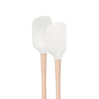 Two white tovolo Flex-Core Mini Spatula + Spoonula with wood handles stand upright side by side against a plain white background.