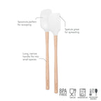 The tovolo Flex-Core Mini Spatula + Spoonula with wood handles features white silicone heads for spreading and scooping. BPA free, food safe, dishwasher safe, and heat resistant.
