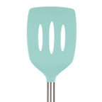 The tovolo Silicone and Stainless Steel Slotted Turner features a light blue silicone head with three oval slots, a stainless steel handle, and is safe for nonstick cookware. Shown against a white background.