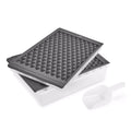 The tovolo Twist and Release Mini Ice Set includes a white rectangular storage bin, two stacked gray trays with triangular grids, and a white plastic scoop.