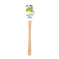 The Summer Spatulart is a durable kitchen utensil with a wood handle and a white silicone head decorated with lemons, leaves, and "squeeze the day" in blue cursive.