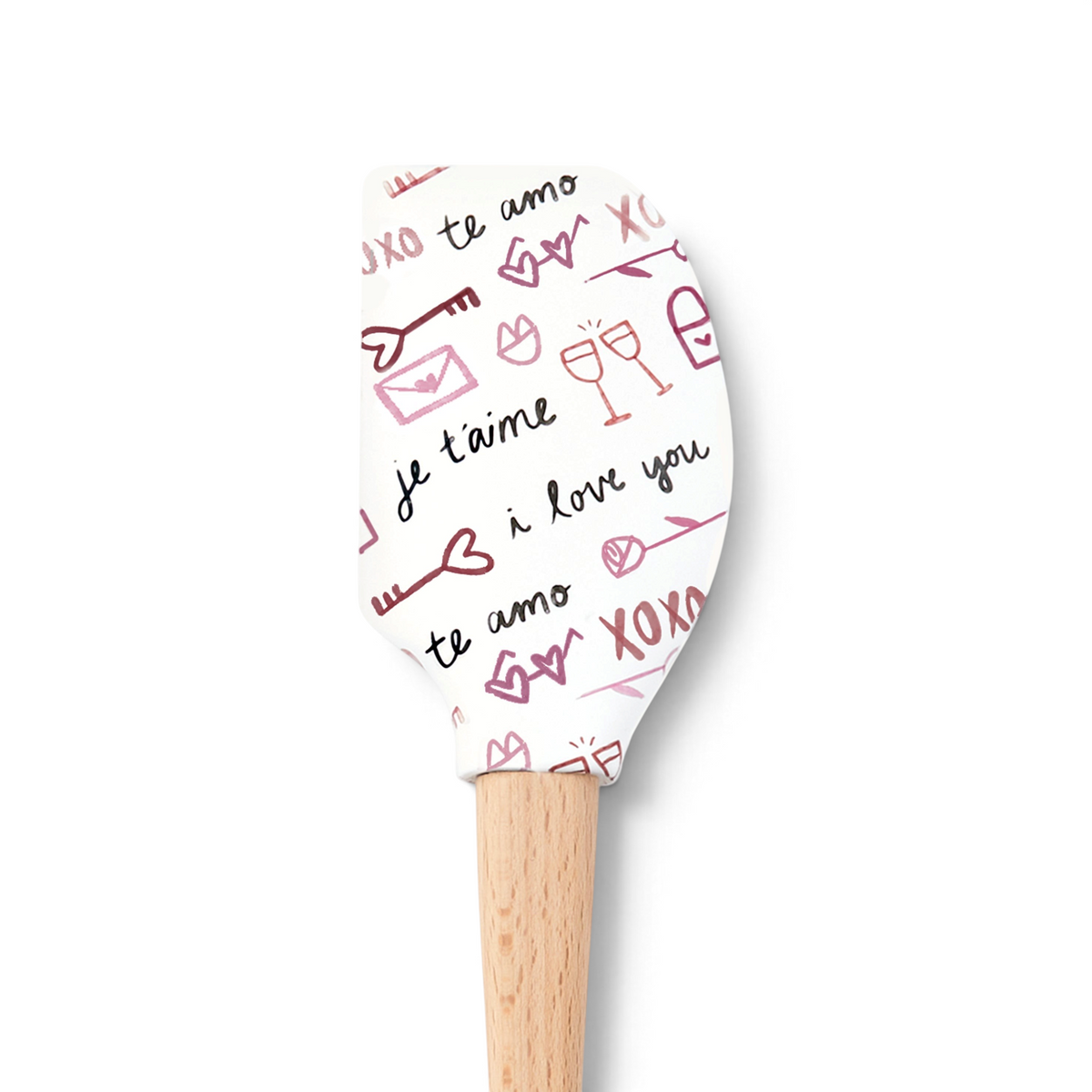 The Spring Spatulart is a white silicone spatula with a wooden handle, decorated with pink and red hearts, champagne glasses, envelopes, XO symbols, and "I love you" in English, French, and Spanish—perfect for adding love to your kitchen.