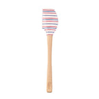 The Summer Spatulart features a durable white silicone head with red, blue, and black stripes and a wood handle engraved at the base. Set on a plain white background, this kitchen utensil blends style and function.