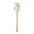 The Autumn Spatulart features a wood handle and a silicone head decorated with vibrant peaches and green leaves, adding a charming touch to any home chef's kitchen.
