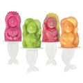 Four colorful mermaid-shaped Pop Molds in pink, green, red, and orange rest on white holders with mermaid tail handles—perfect for creating homemade frozen treats.