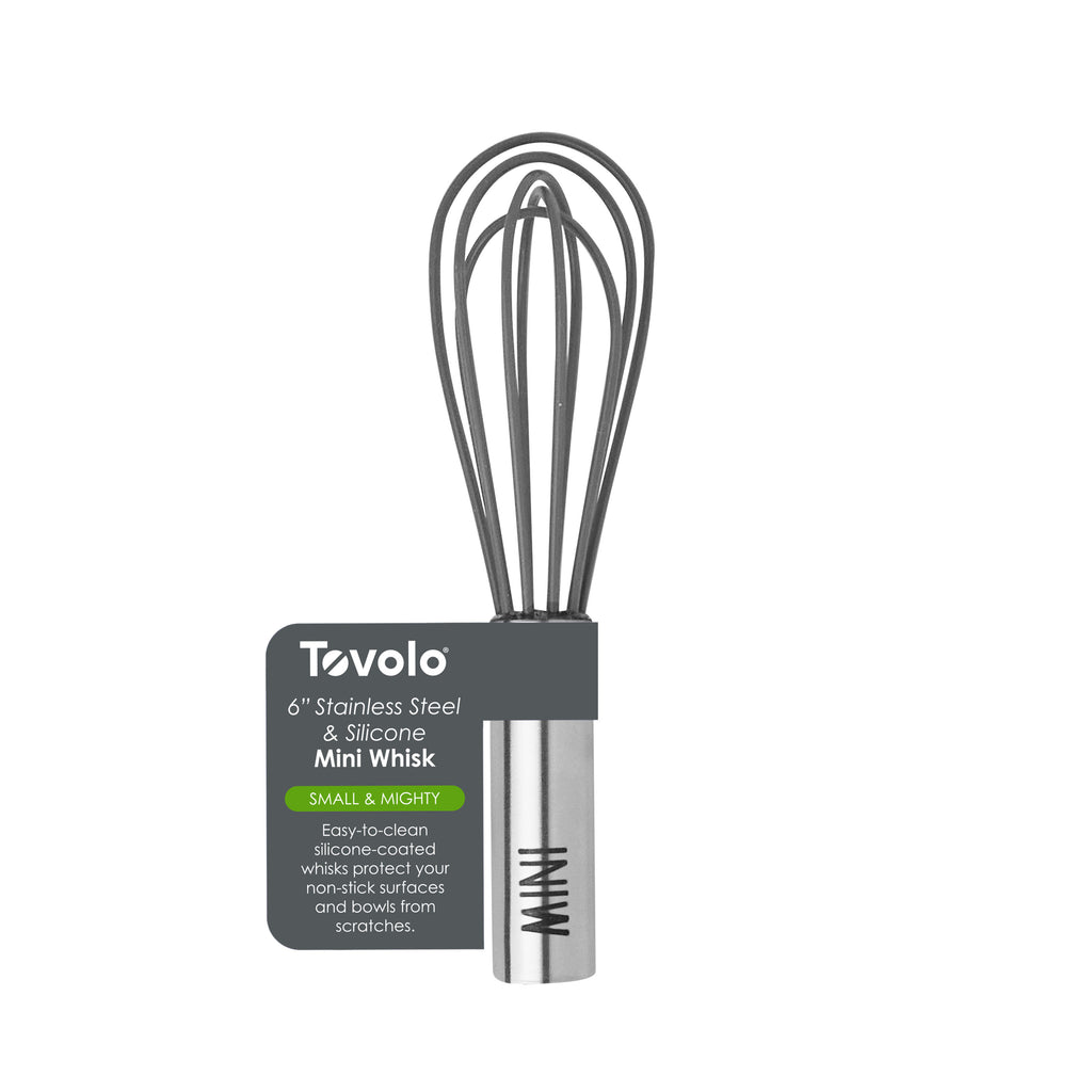 The Mini Whisk is a 6-inch Tovolo whisk with a stainless steel handle and gray silicone, ideal for quick whisking and safe for non-stick surfaces. Packaging comes attached to the handle.