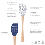 The Kitchen Hacks Spatulart set includes two wood-handled spatulas with blue and white baking designs. Made from eco-friendly silicone, they feature rounded corners, ergonomic handles, and baking measurements—ideal as a baking conversion spatula set.