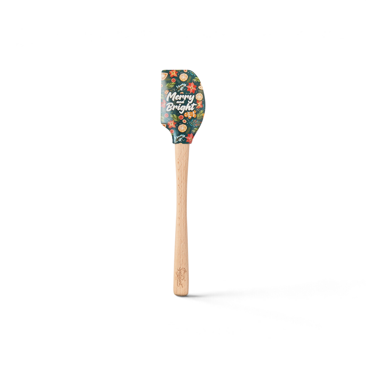 The Holiday Spatulart features a wooden handle, silicone head, festive patterns, and "Merry & Bright" in white script—perfect for holiday baking or as a charming gift.