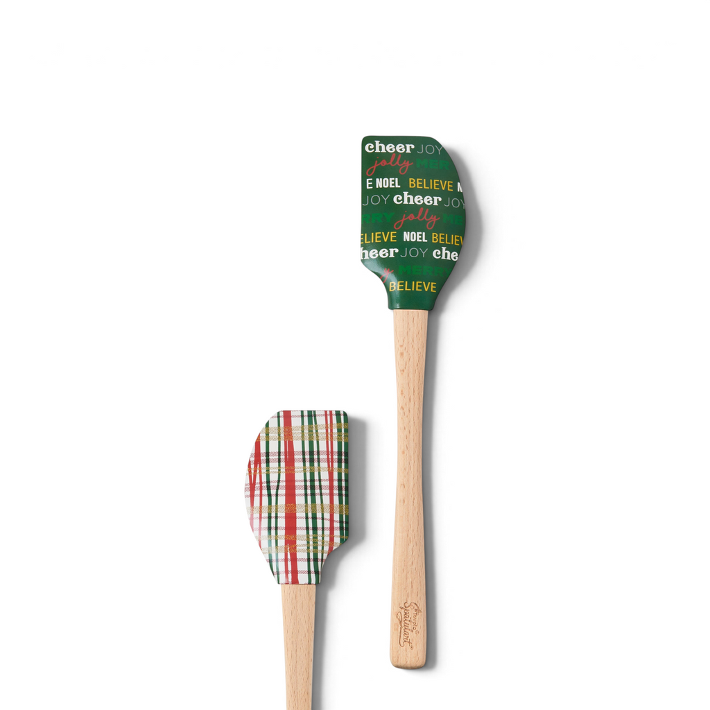 Holiday Spatulart includes two silicone spatulas: one with merry words on green and another with a red, green, and white plaid pattern—perfect festive accents for seasonal baking or gift wrapping.