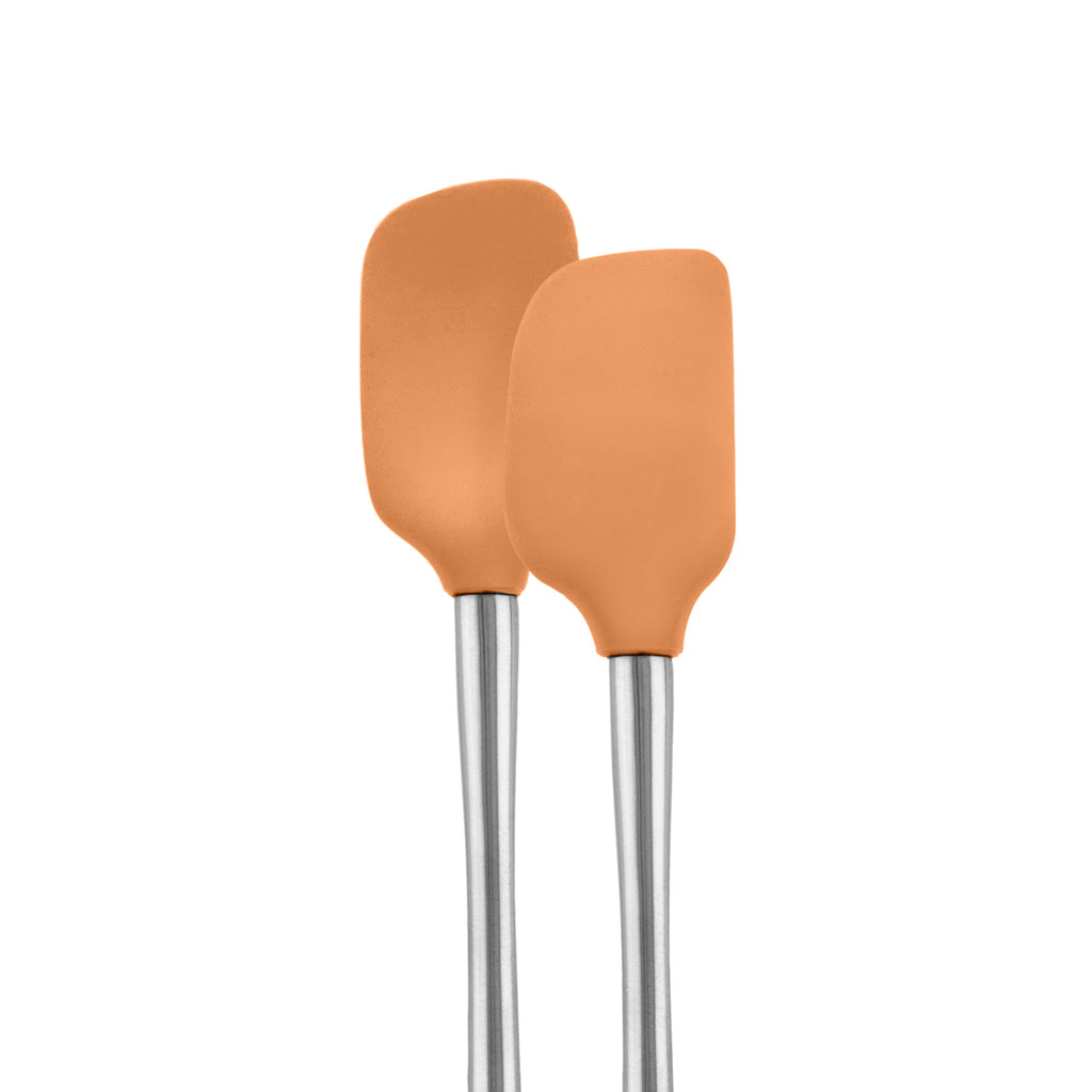 The Tovolo Flex-Core Mini Spatula + Spoonula with stainless steel handles, both orange silicone kitchen tools, stand upright side by side on a white background.