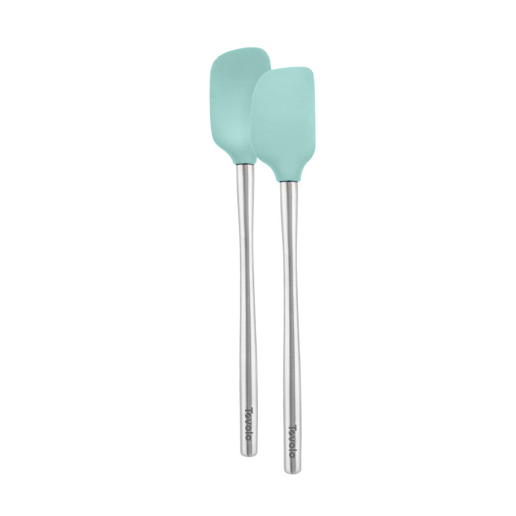 The Flex-Core Spatula + Spoonula set features two heat-resistant utensils with light blue silicone heads and long silver handles, arranged side by side on a white background.