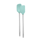 The Flex-Core Spatula + Spoonula set features two heat-resistant utensils with light blue silicone heads and long silver handles, arranged side by side on a white background.