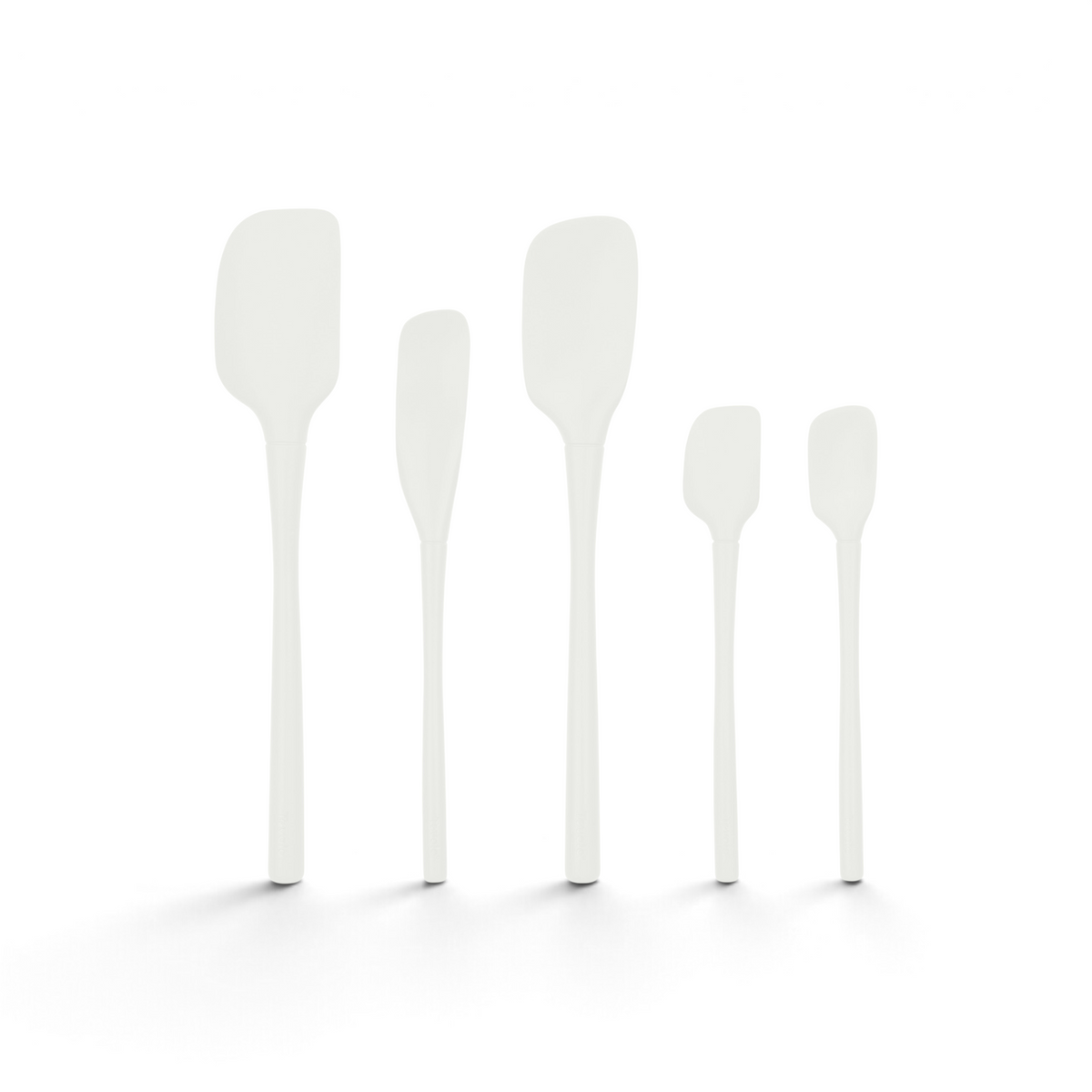 Five white spatulas from the Flex-Core All-Silicone Spatula Set of 5 are arranged upright in a row on a plain white background.