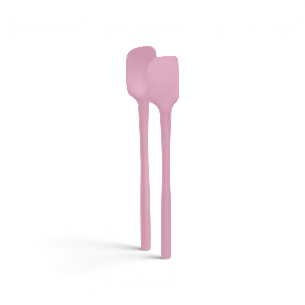 The tovolo Flex-Core Silicone Mini Spatula + Spoonula, both pink and heat-resistant, stand upright side by side against a white background.