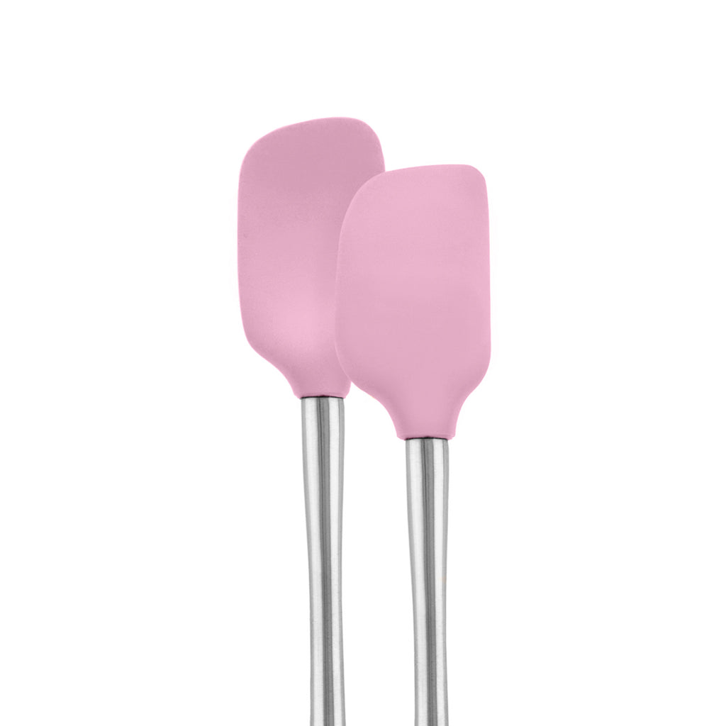 The tovolo Flex-Core Mini Spatula + Spoonula with stainless steel handles and pink silicone heads stand upright side by side against a white background.