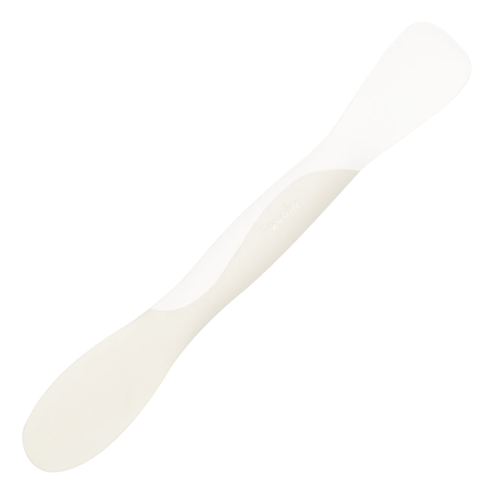 The Scoop and Spread, a white double-ended plastic spatula with one rounded end and one flat end for scooping and spreading, is photographed on a white background.