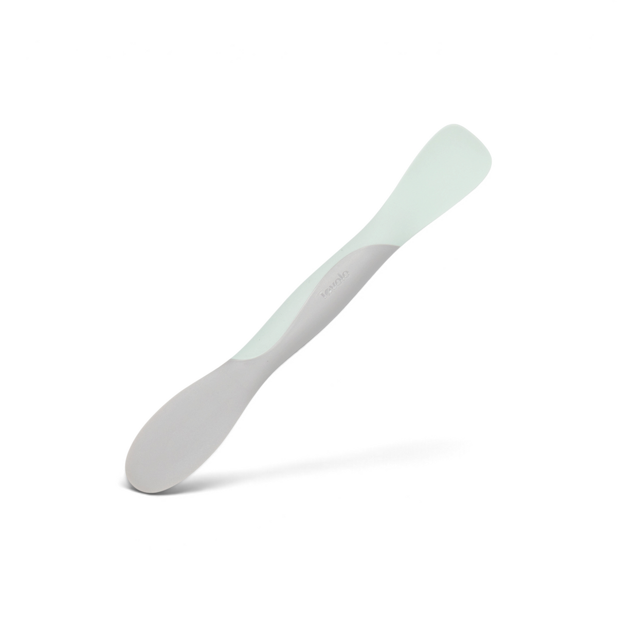 The Scoop and Spread is a silicone baby spoon with a grey handle and pale green scoop, designed as a flexible, dual-ended tool for convenient infant feeding.