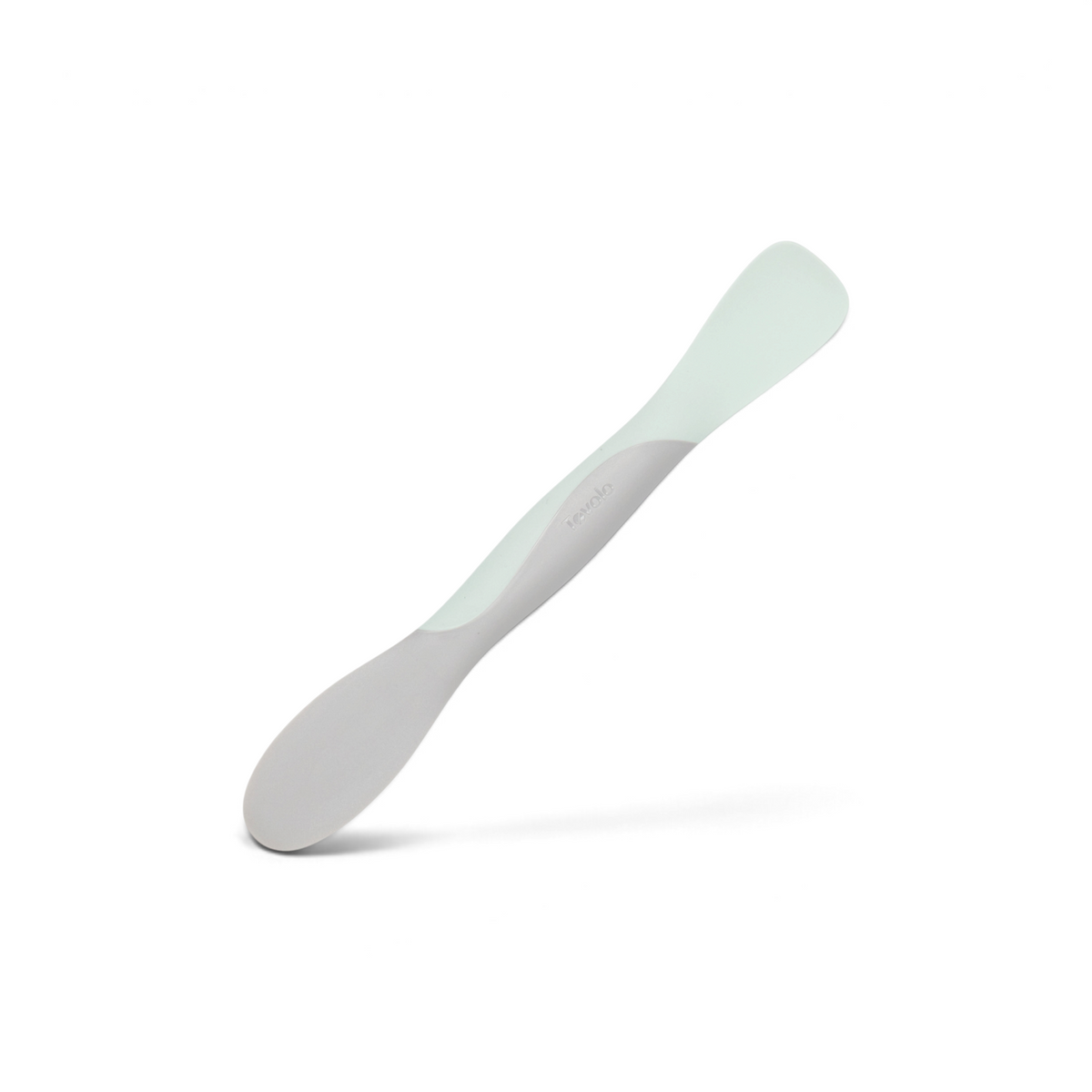 The Scoop and Spread is a silicone baby spoon with a grey handle and pale green scoop, designed as a flexible, dual-ended tool for convenient infant feeding.