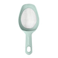 The Scoop and Sift is a light green handheld kitchen strainer with a mesh center and solid handle featuring a hanging hole—ideal as a small sieve for sifting flour.
