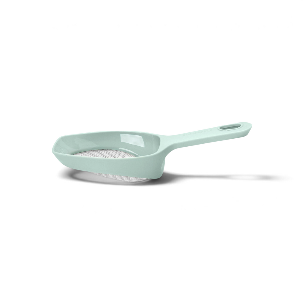 The Scoop and Sift is a light green plastic handheld strainer with a fine mesh screen, a long handle, and a wide, shallow bowl—perfect for sifting flour or scooping and sifting dry ingredients.