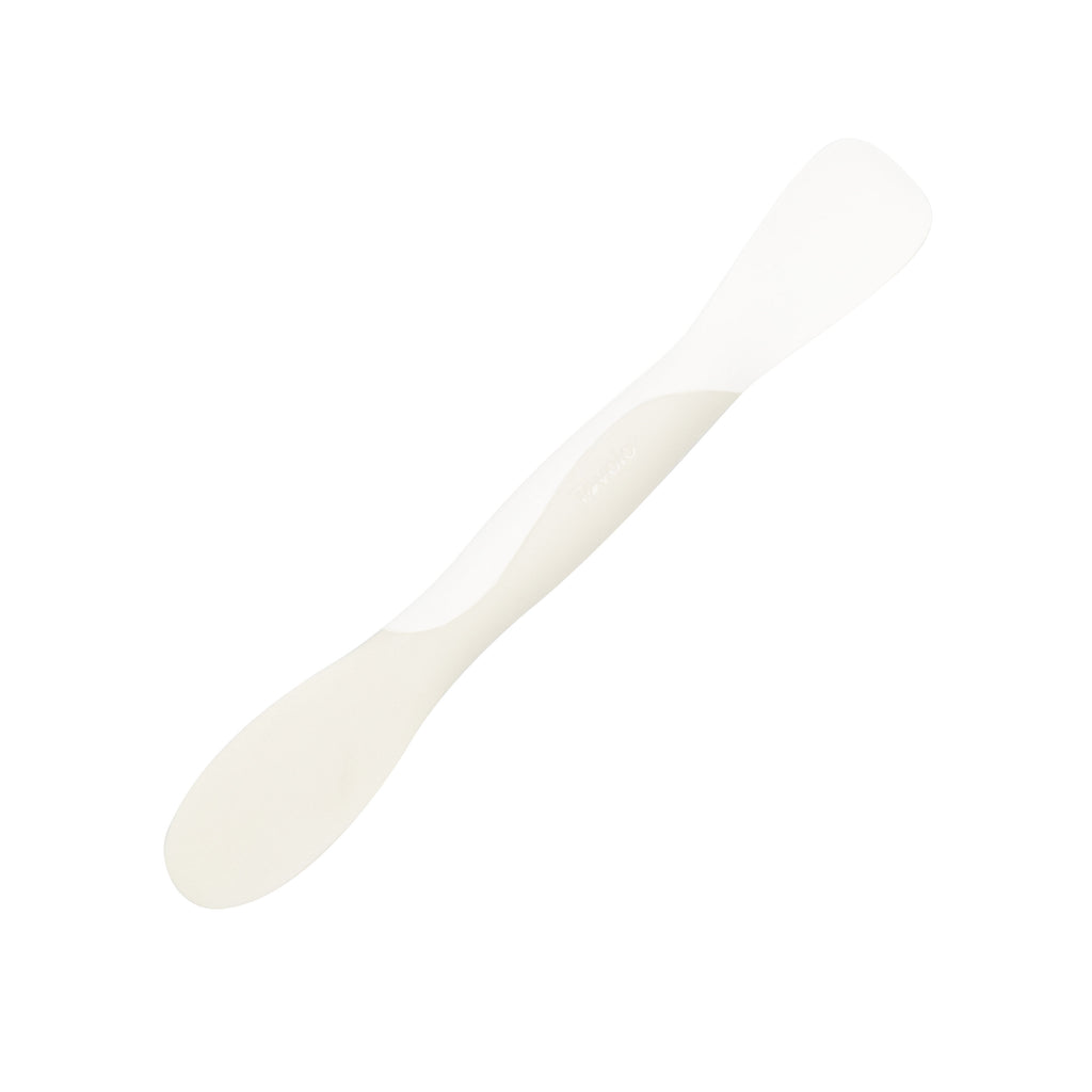 The Scoop and Spread is a white plastic spatula with two flat, rounded ends, shown on a plain white background—an essential tool for bakers.