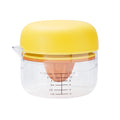 The All-in-One Juicer is a clear plastic citrus juicer with a yellow lid, orange reamer, cup/ounce markings, built-in zester, and a spout for easy pouring.