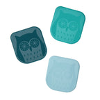 Three square containers in teal and blue with charming owl designs on the lids, ideal for storing your Pan Scrapers or non-stick bakeware accessories, are displayed diagonally against a white background.