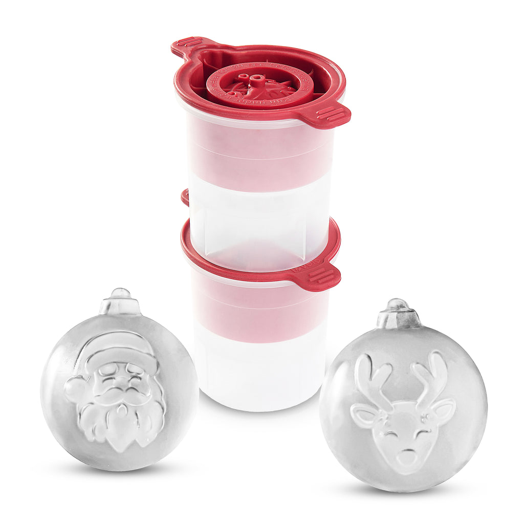 Two tovolo Santa and Reindeer Ornament Ice Molds (Set of 2), white and spherical with raised festive designs, are shown in front of two stacked clear plastic containers with red lids.