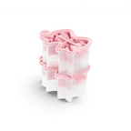 The tovolo Fancy Bow Ice Molds (Set of 2) in pink and white are arranged on a white background, ideal for making creative popsicles.