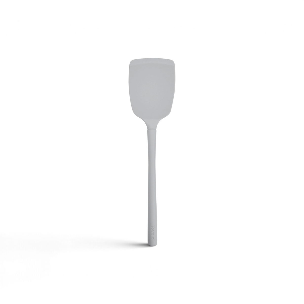 The tovolo Flex-Core Silicone Solid Turner features a gray, flat rectangular head and a long handle, displayed against a plain white background.