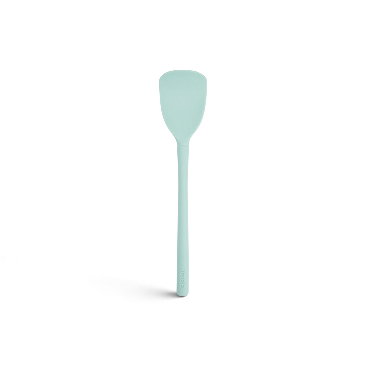 The Flex-Core Scoopula is a light blue silicone spatula with a flat, broad head and a long handle, displayed against a white background.