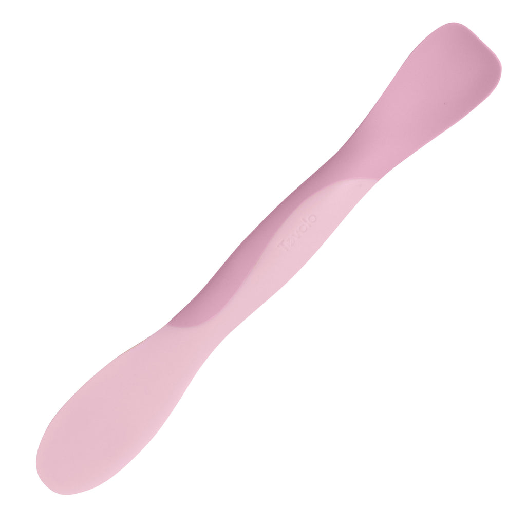 The Scoop and Spread is a double-ended silicone spatula in light and dark pink with rounded edges, shown on a white background—an essential tool for bakers.