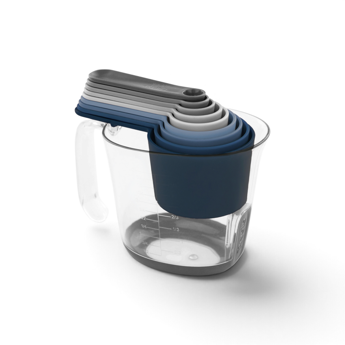 The Magnetic Nested Measuring System in blue and gray fits neatly inside a clear plastic jug with a handle, keeping your kitchen organized and stylish.