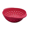 The Mini Berry Colander is a red plastic colander with round holes and two handles, ideal for washing fruit or draining pasta and vegetables. Shown on a white background.